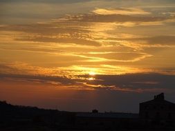 sun in the clouds at sunset