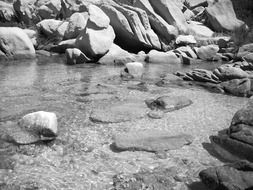 Black and white landscape photo of the rocks in water