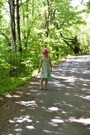 girl is walking along a forest path