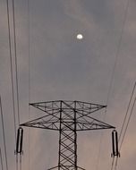 electric pylon on a background of the moon