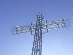 metal cross on top of a mountain