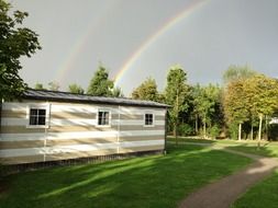 double rainbow over striped cabin
