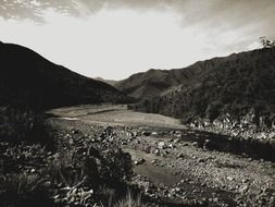 creek in mountains black and white photo