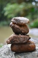 macro view of stack of stones on a rock on river