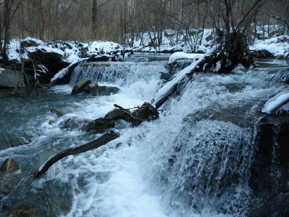 river with a waterfall in winter