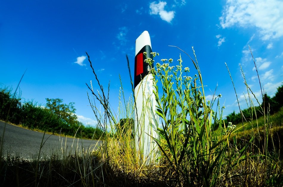 pillar in grass at edge of road, hungary