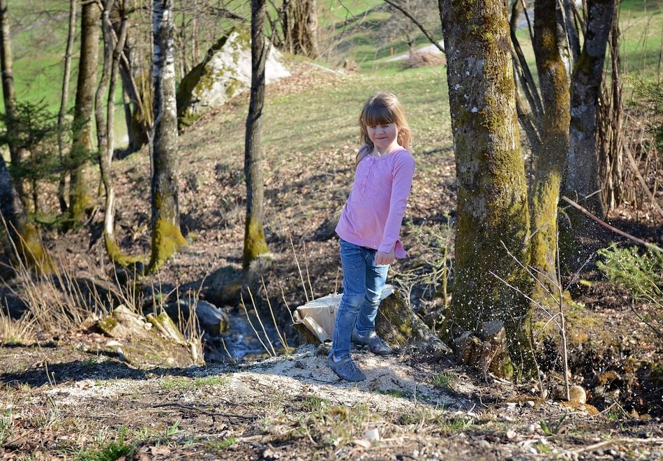 human child girl blond in the spring forest