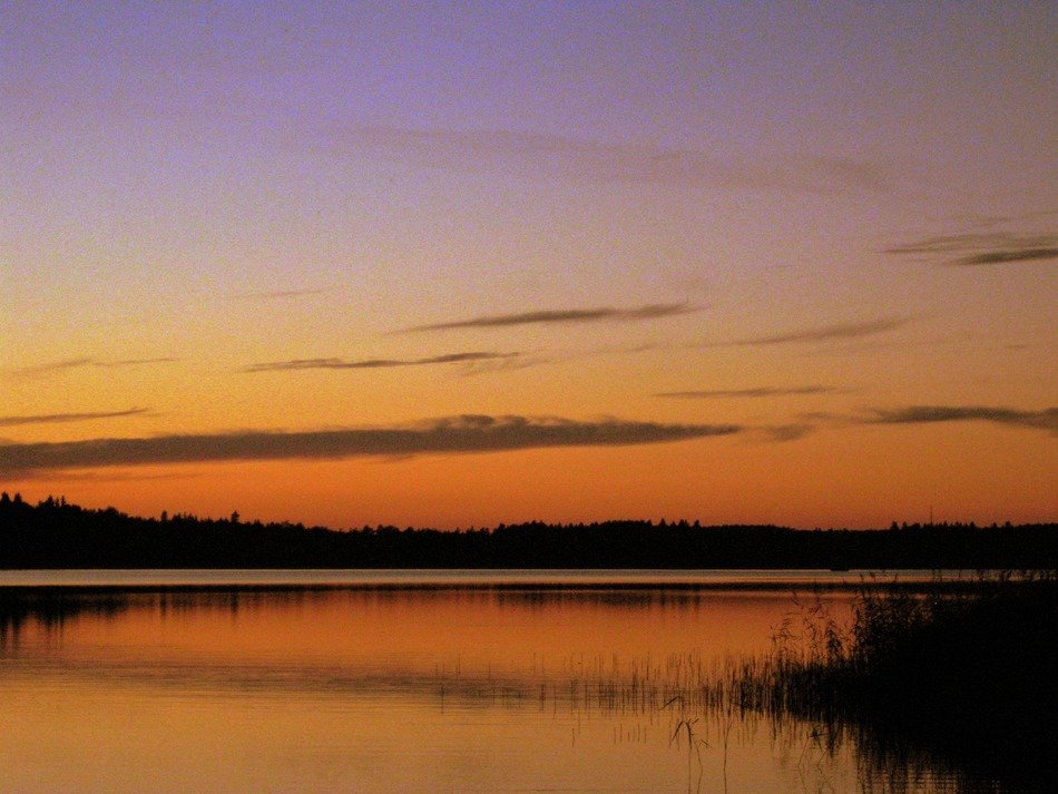 Romantic orange sunset over a lake in Sweden