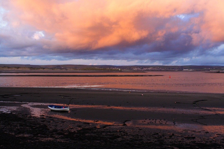 Boat on the coast during sunset