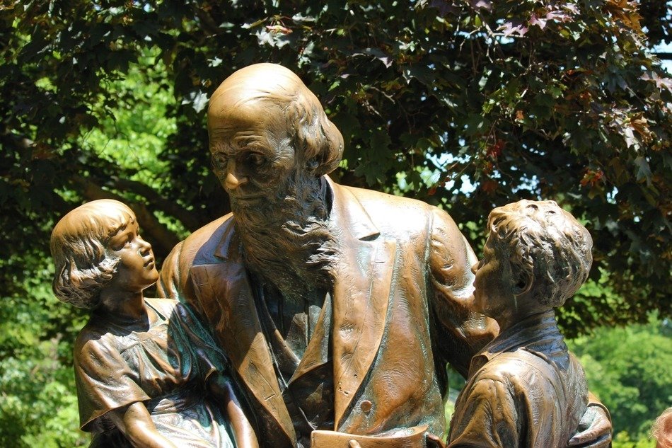 bronze monument to John Boll with kids