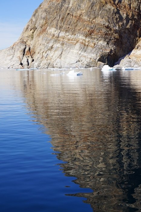 mirror image of a mountain in the water