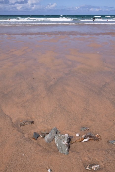 small stones on sand at sea