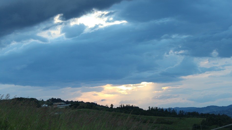 dark clouds in the sky over the mountains