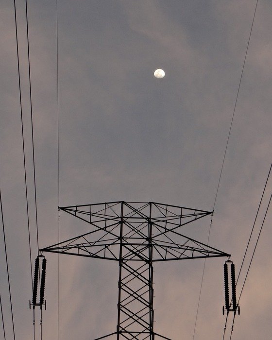 electric pylon on a background of the moon