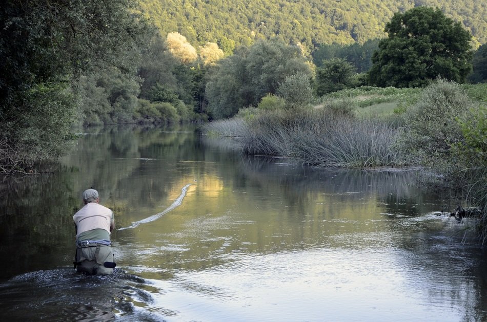 fisherman on the water against the background of the picturesque landscape