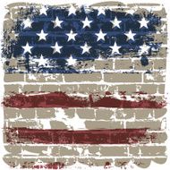 The American flag against a brick wall