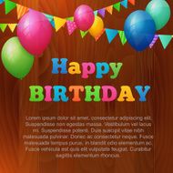 happy birthday greeting card with balloons on wood background