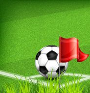 Football (soccer) ball on corner of field and flag