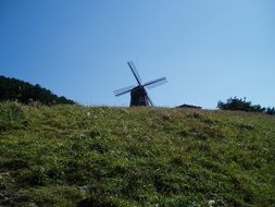 windmill on top of a green hill