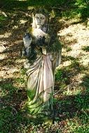 stone sculpture of jesus in the garden