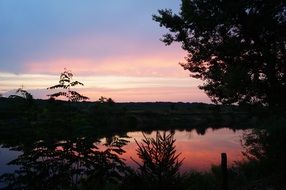 colorful reflection of sunset on lake at summer