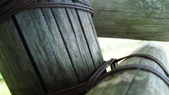 wooden logs tied by metal wires close-up