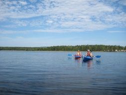 people in canoes on lake