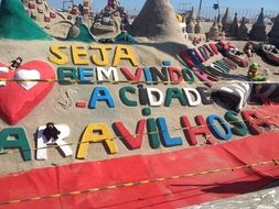 Colorful and beautiful inscription on the beach in Rio de Janeiro, Brazil