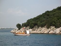 boat against a rocky coast of Turkey