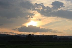clouds and bright sun on a gray sky