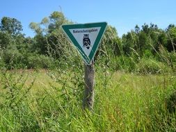 triangular sign on a pole in the reserve