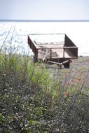 old damaged trailer on beach at mediterranean sea