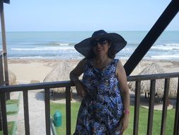 madam in a hat on the beach