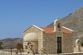 chapel near the mountain on a sunny day