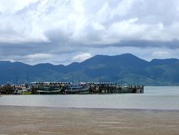 boats at long pier near green mountain coast