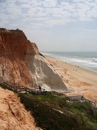 Red sand on the ocean coast