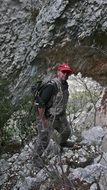 mountain hiker, mature man staying on rock