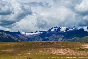 clouds over the snow-capped mountains