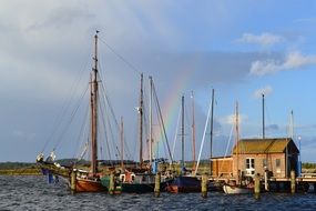 rainbow over the boats in the port