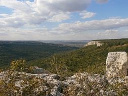 forested mountains beneath fluffy clouds at summer, bulgaria