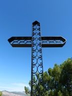 metal cross against the blue sky