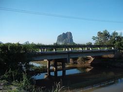 distant view of the mountain through a small bridge