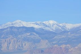 snow mountain over red rock