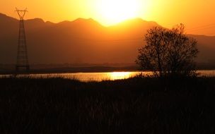 sun shining from behind mountains