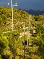 power lines along green mountains