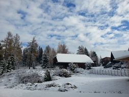 Village in the winter against the sky with white clouds