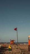 flag near the rescue tower on the beach