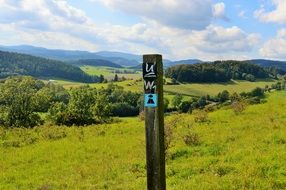 direction sign on hiking trail at scenic landscape