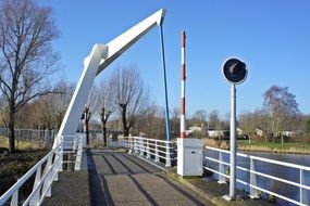 white bridge with traffic light and barrier