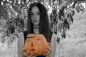 orange halloween pumpkin and black and white girl